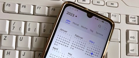 Smartphone auf Tastatur mit Kalender 2023 Smartphone auf Tastatur mit Kalender 2023